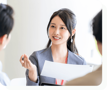 女性が男性2名と話をしている